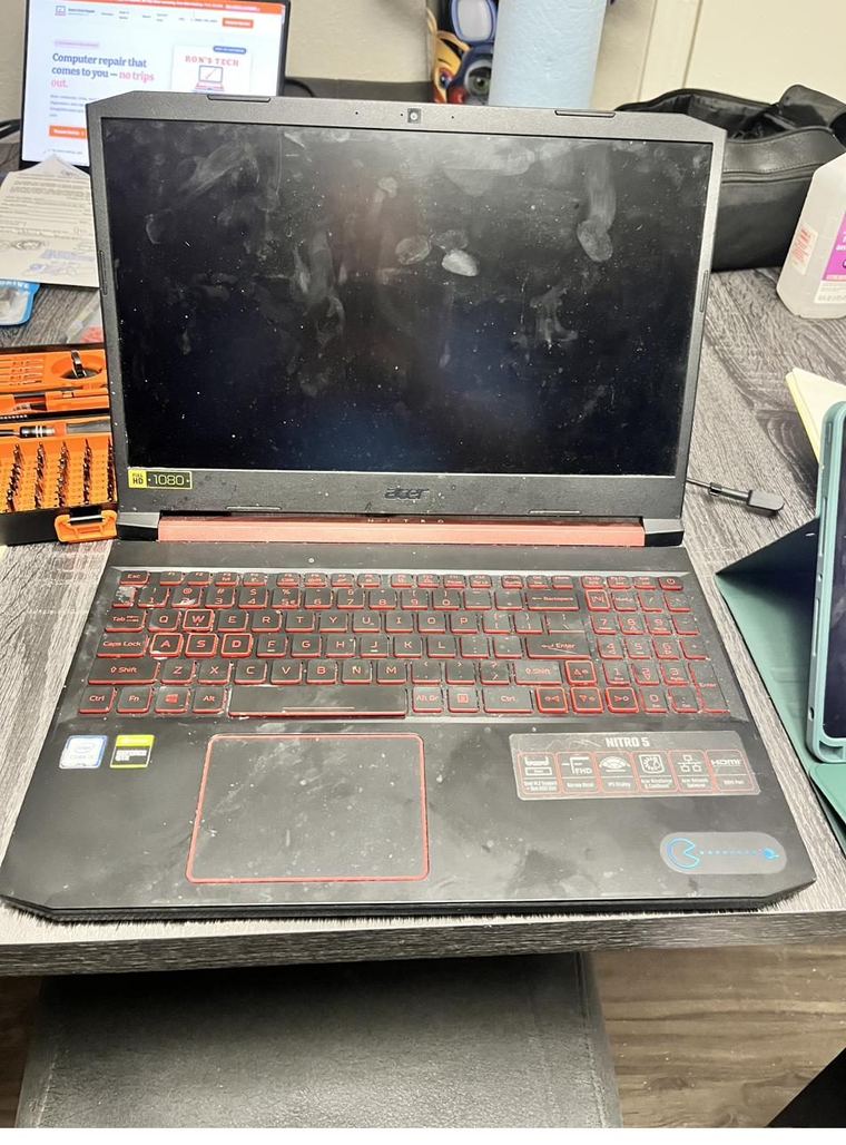 Laptop screen and keyboard covered in dust and grime before cleaning