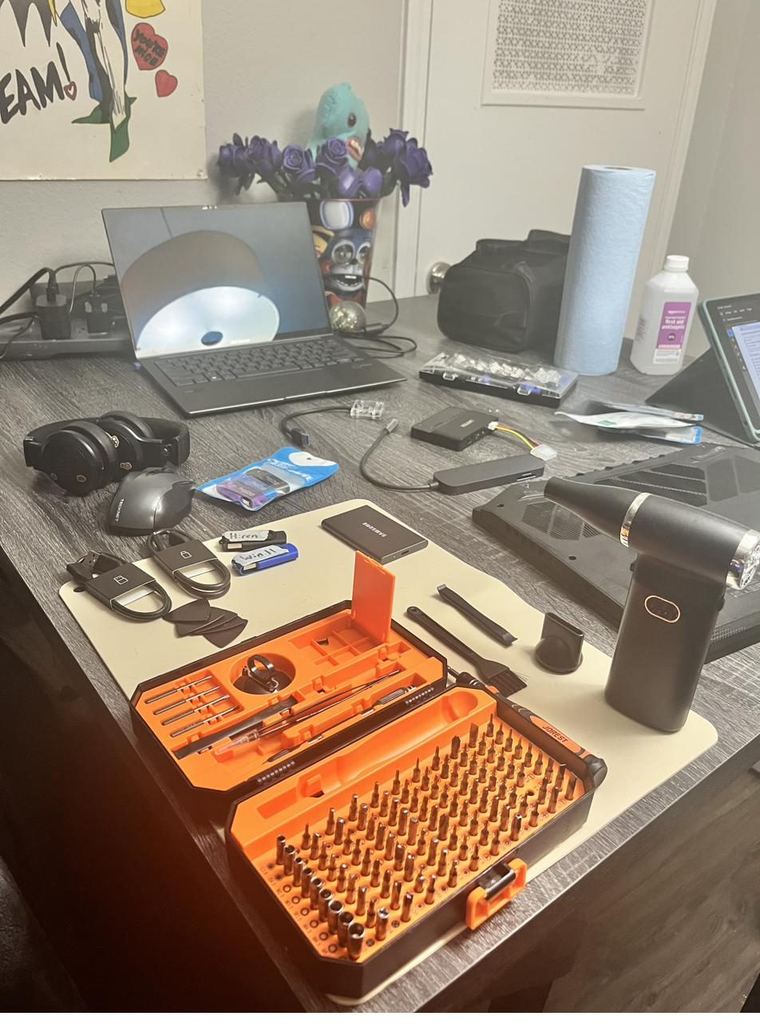 Repair bench with tools, screwdriver set and laptop laid out
